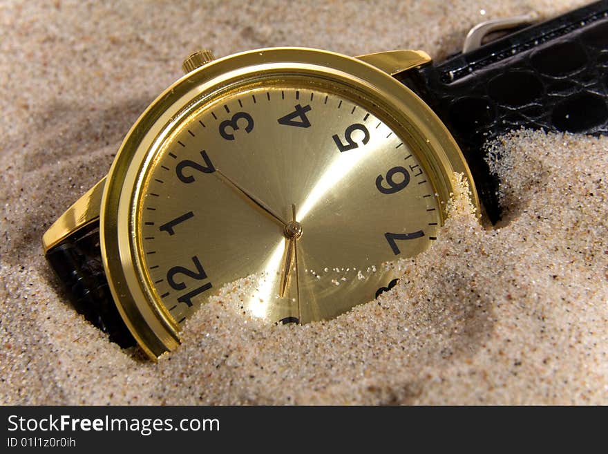 Clock on sea sand bacground