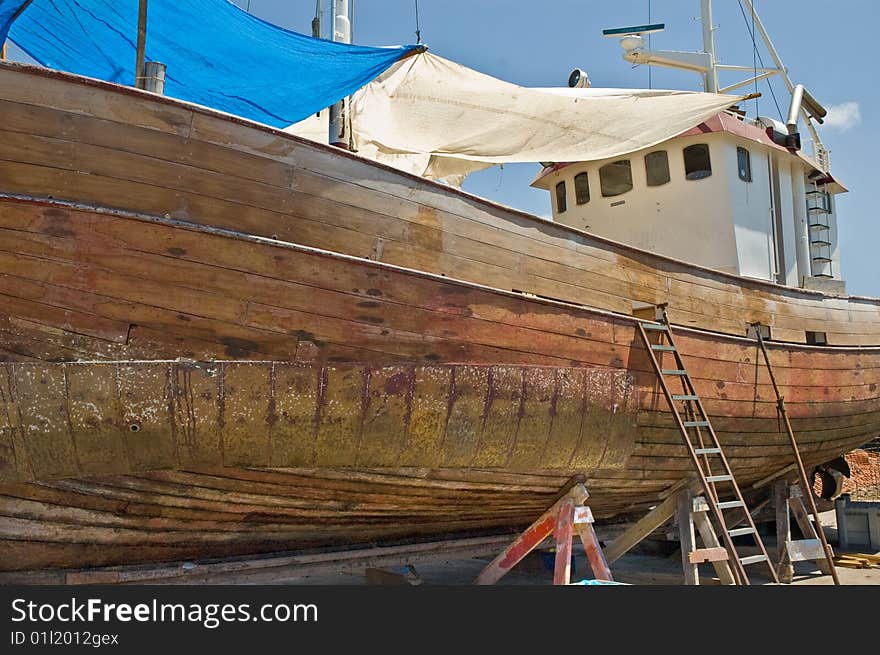 An old fishing boat under going maintenance on the island of Tenerife. An old fishing boat under going maintenance on the island of Tenerife