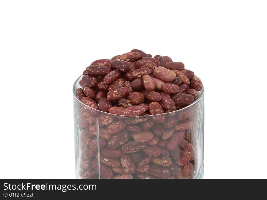 Haricot beans in the transparent glass isolated over white