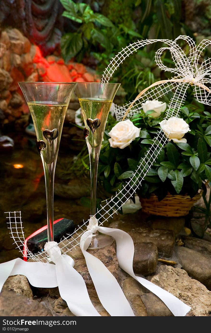 Wedding composition with glasses, champagne and flowers