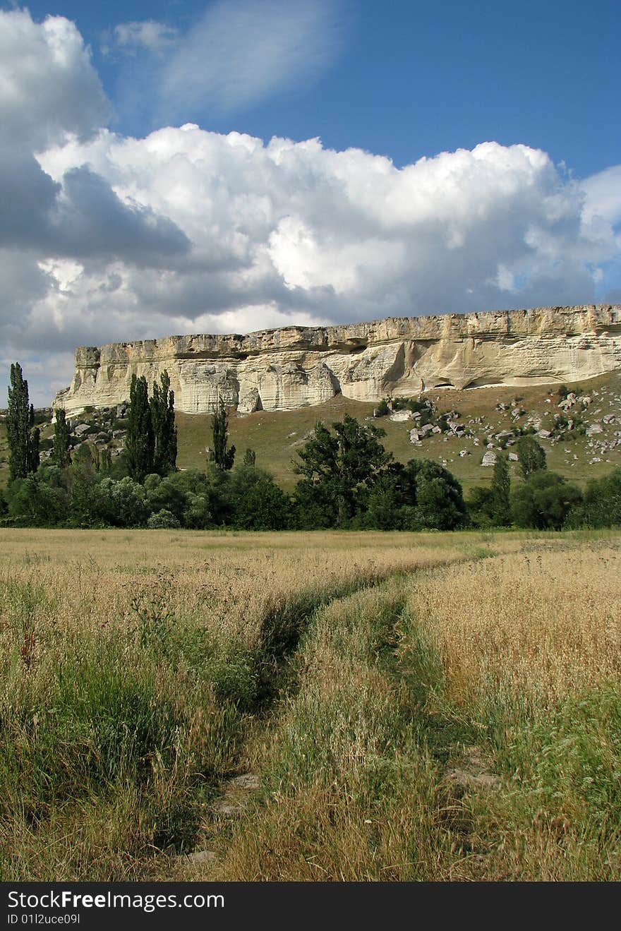 Summer landscape. Scenic cliff in the steppe. Cloud-drift. Summer landscape. Scenic cliff in the steppe. Cloud-drift.