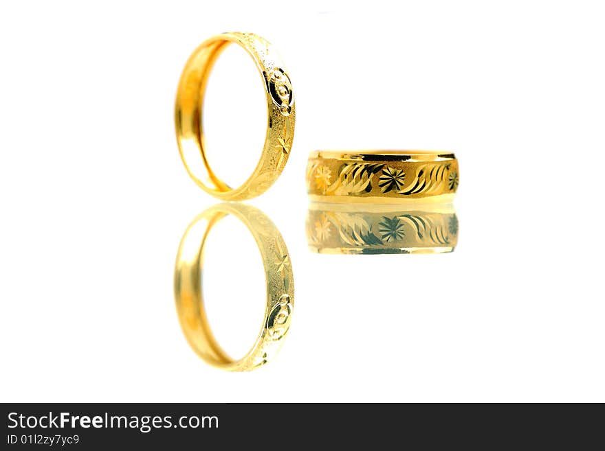 Two golden rings standing on white background.