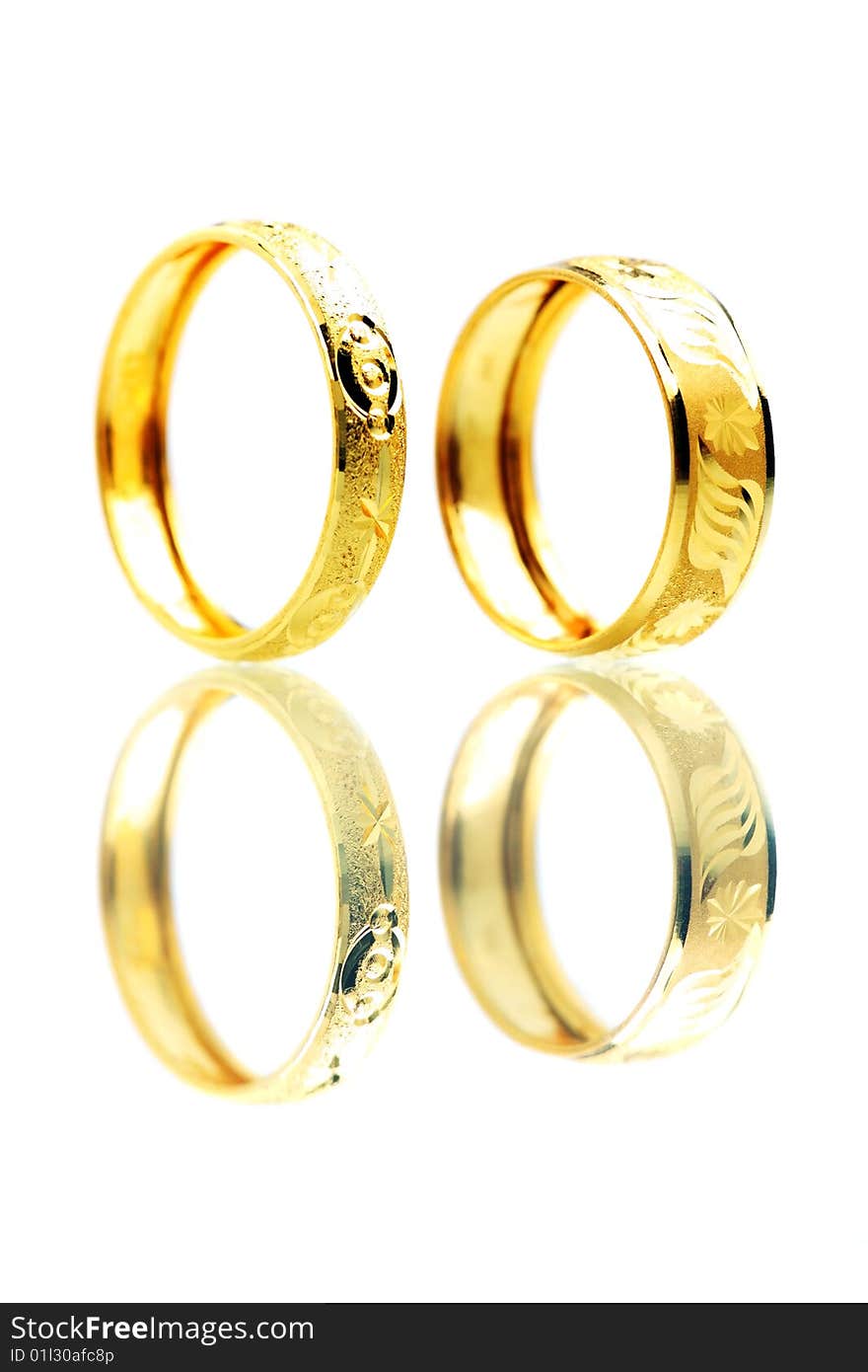 Two golden rings standing on white background.