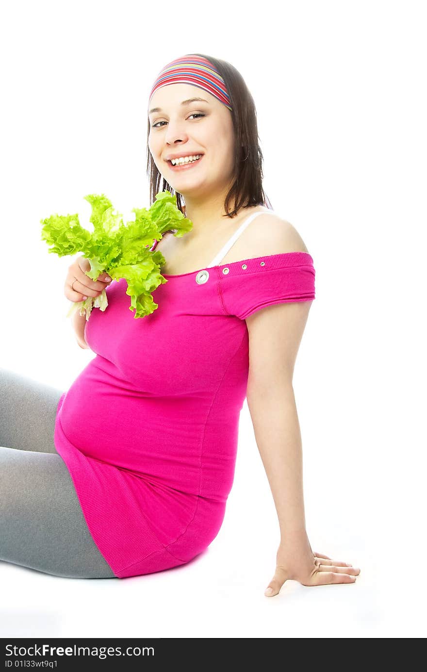 Portrait of a happy young pregnant woman eating green salad. Portrait of a happy young pregnant woman eating green salad