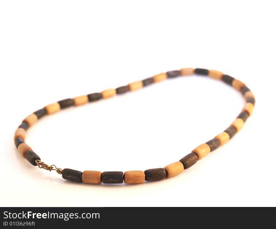 Simple wooden necklace, white background, black and light beads. Simple wooden necklace, white background, black and light beads