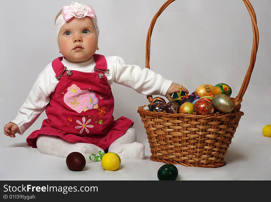 Little girl with basket and Easter eggs