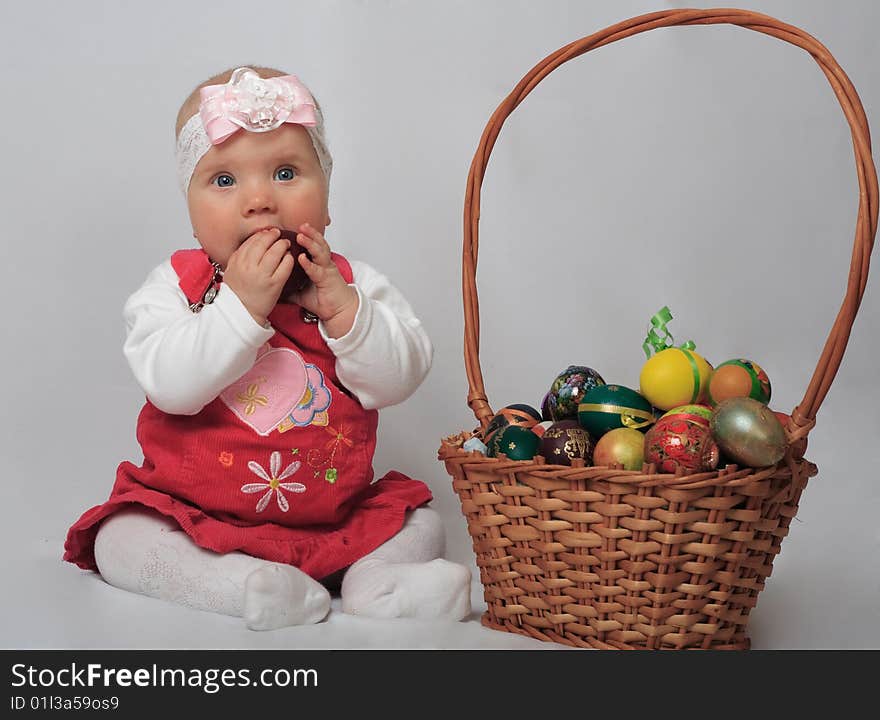 Little girl with basket and Easter eggs