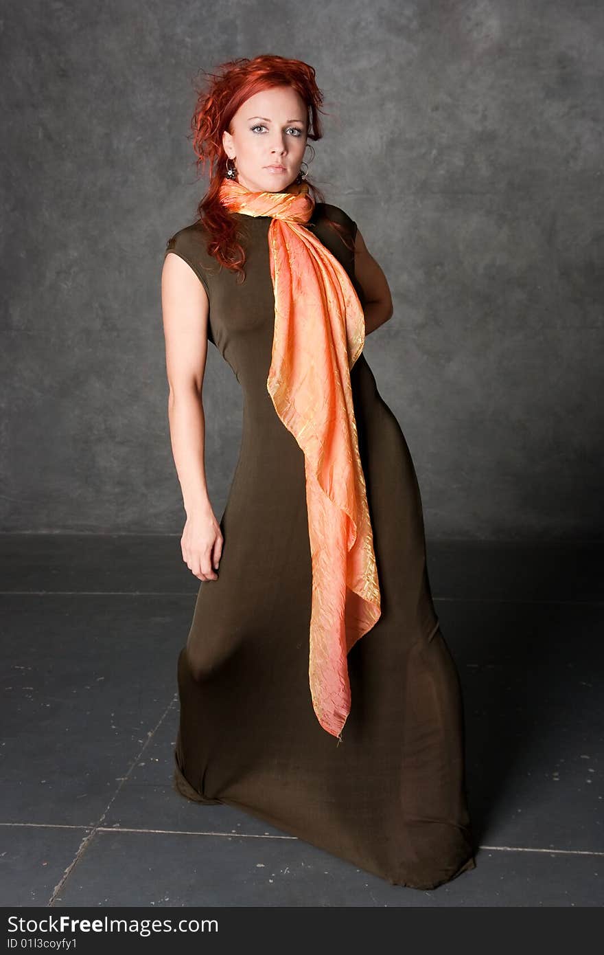 The girl in a long dress with an orange scarf