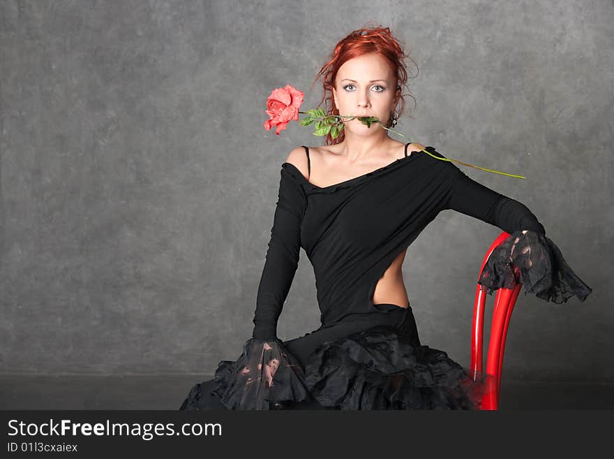 The charming girl with a red rose