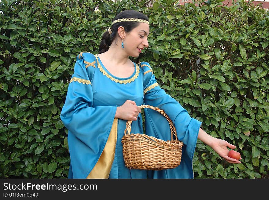 Medieval lady offering red apples