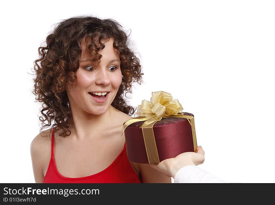 Beautiful woman with a gift. Attractive girl holding purple box with gold ribbon. Woman is surprising at present. Isolated over white background. Beautiful woman with a gift. Attractive girl holding purple box with gold ribbon. Woman is surprising at present. Isolated over white background.