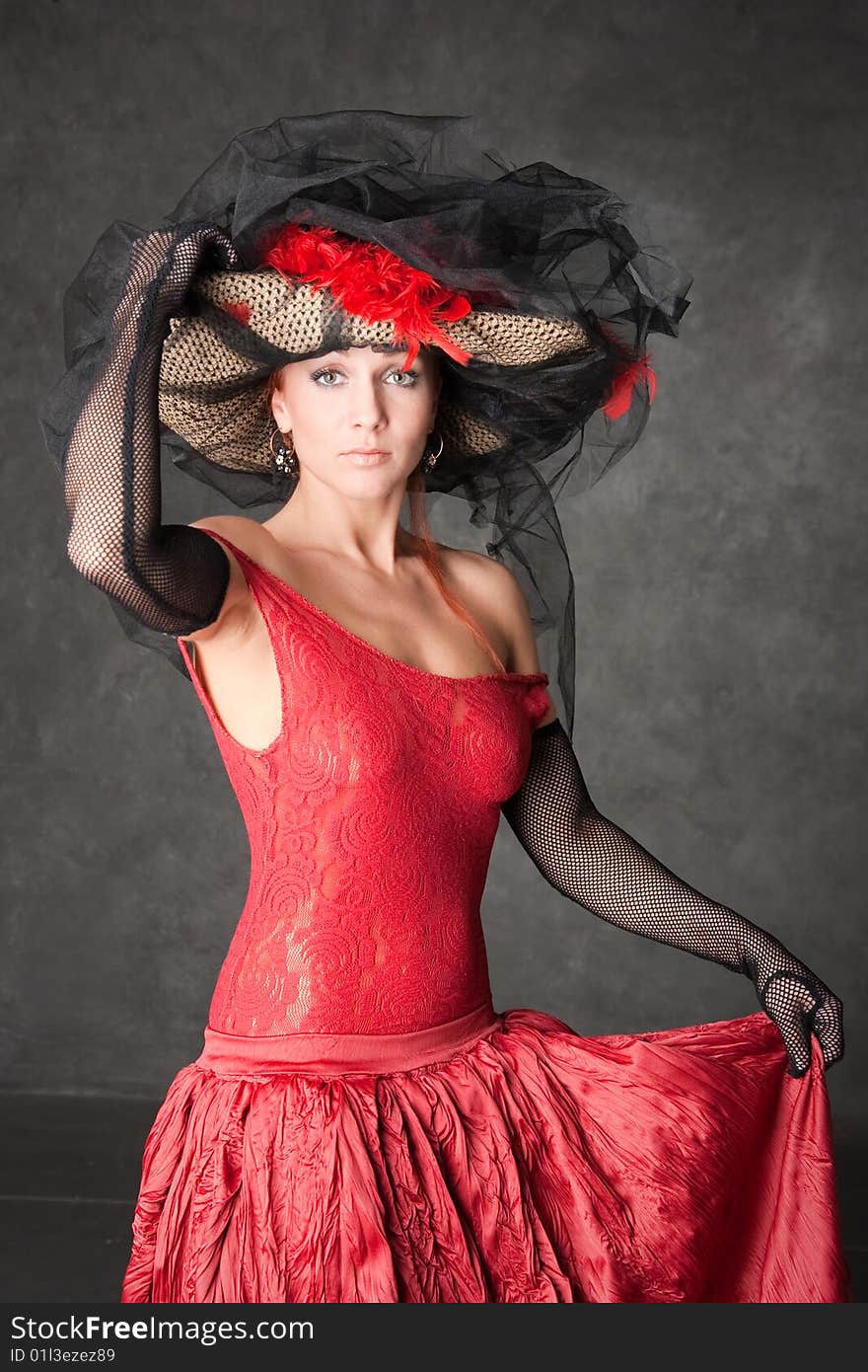 The charming girl in a beautiful red dress