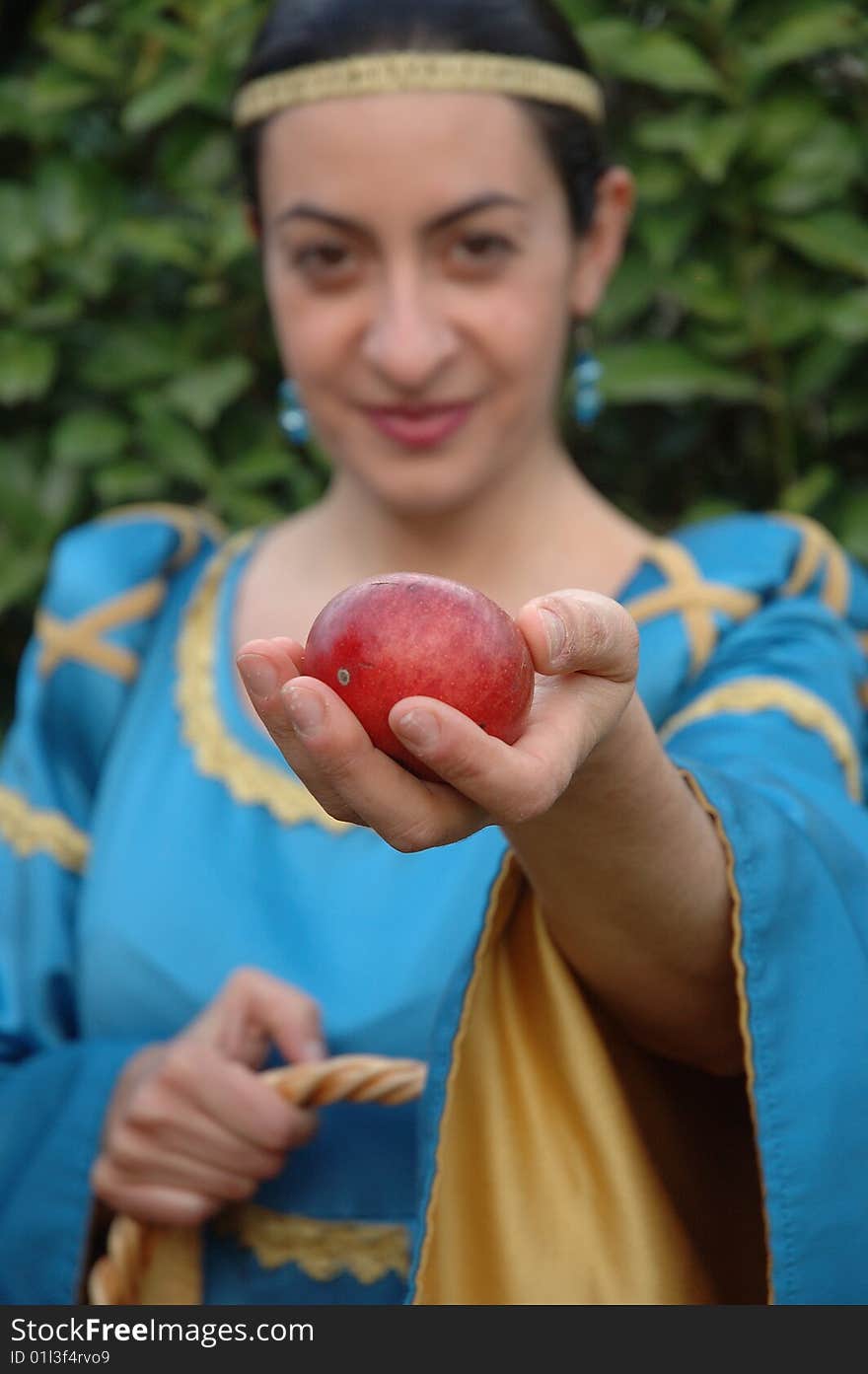 Medieval lady offering red apples