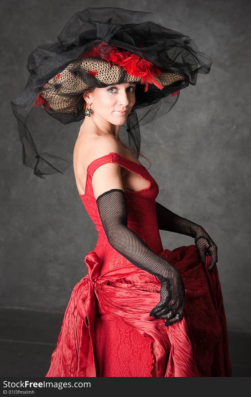 The charming girl in a beautiful red dress