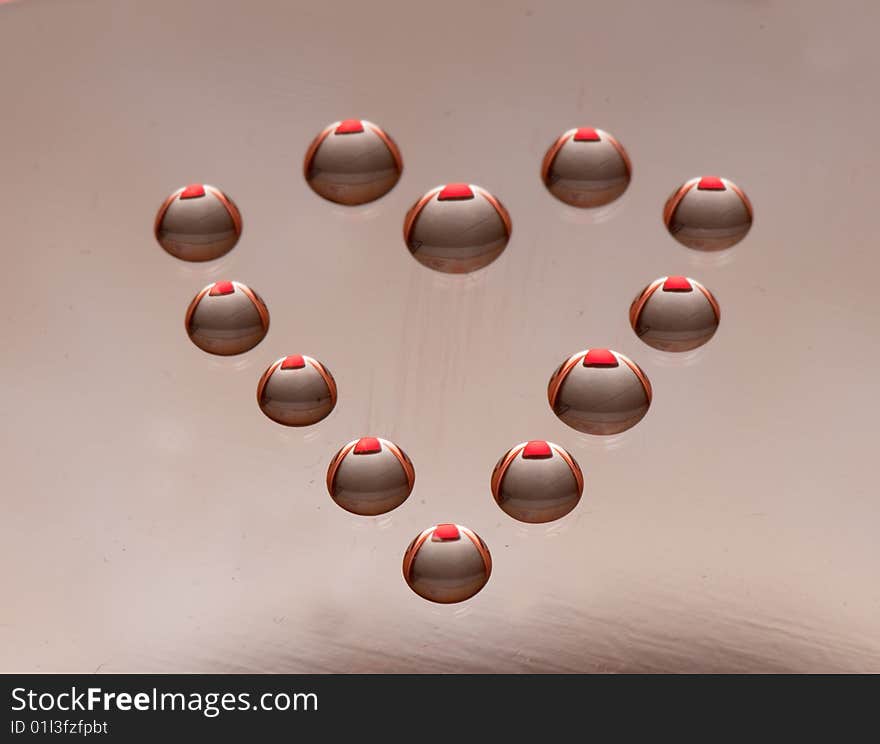 Water drops in the form of heart on a celebratory background