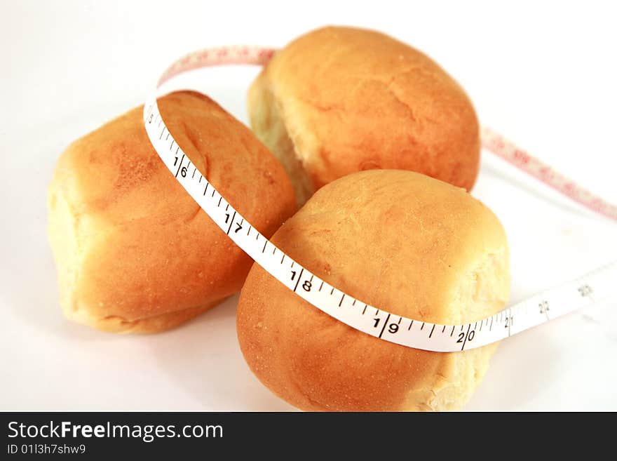 An image of dinner rolls with tape measure. An image of dinner rolls with tape measure