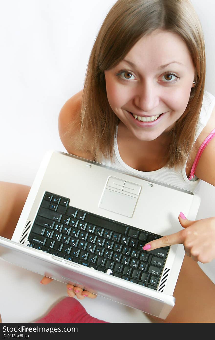 Beautiful female student relaxing with her laptop.