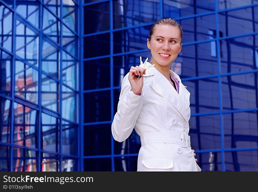 Business women in white on business architecture background. Business women in white on business architecture background