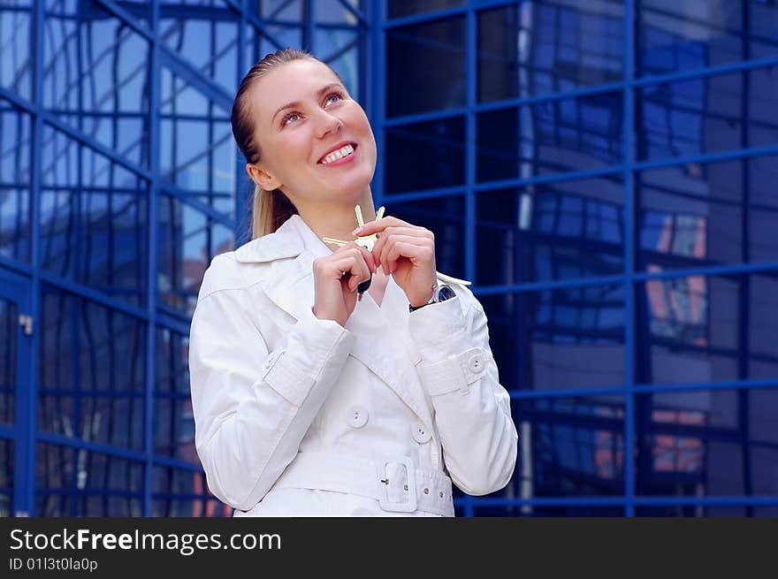 Business women in white on business architecture background. Business women in white on business architecture background