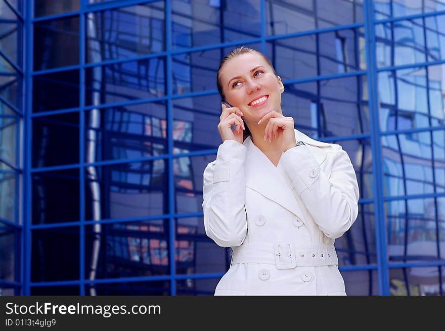 Business women in white on business architecture background. Business women in white on business architecture background