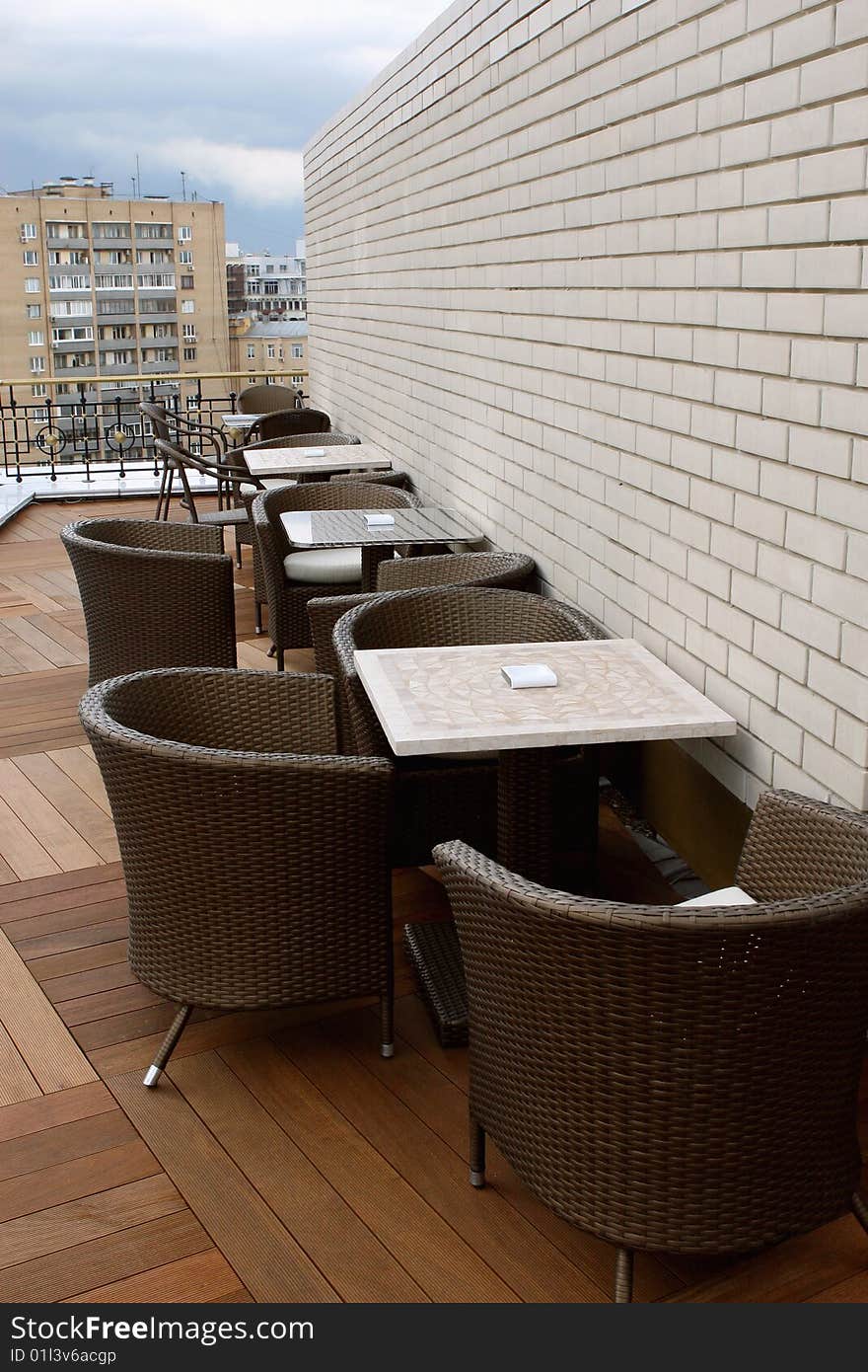 Summer cafe on a house roof. Cityscape.