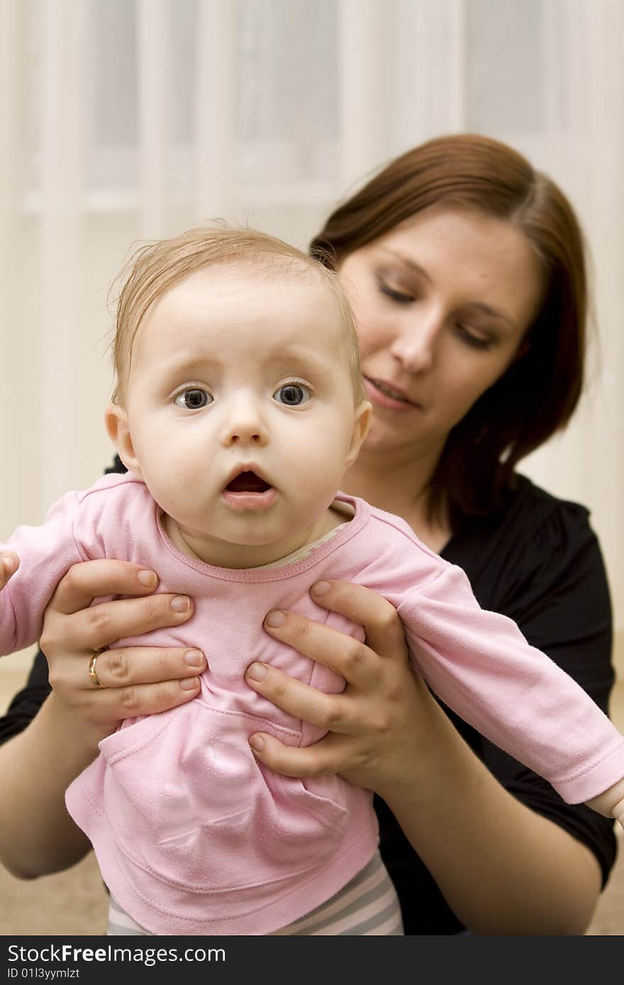 Mother and baby playing at home