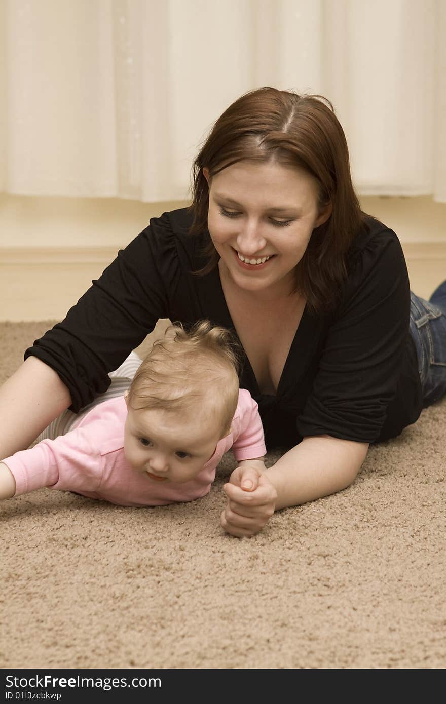 Mother and baby playing in home