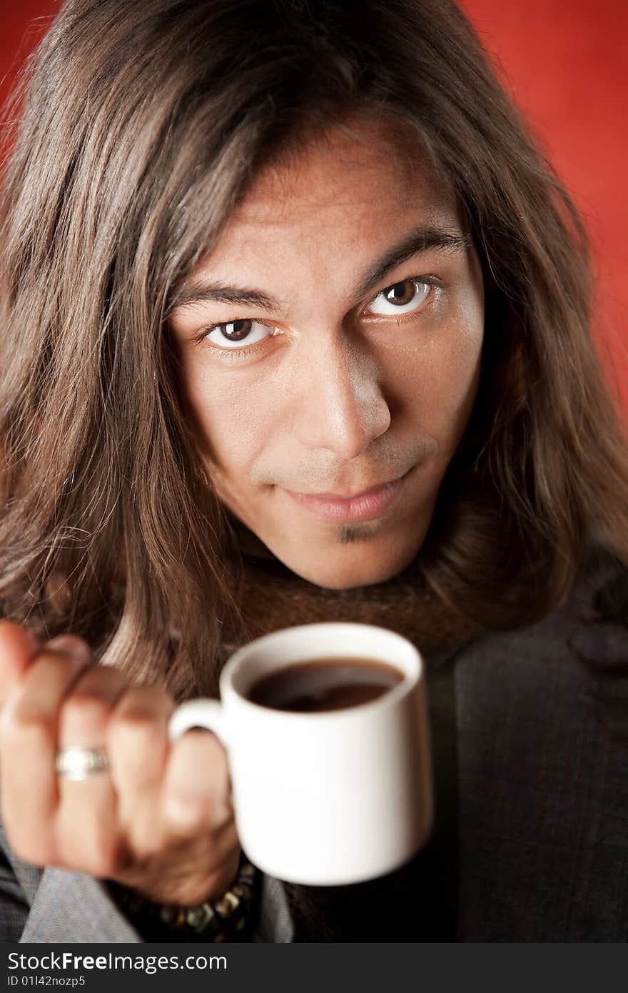 Closeup Portrait of a Handsome Young Man with Long Hair Drinking Coffee. Closeup Portrait of a Handsome Young Man with Long Hair Drinking Coffee