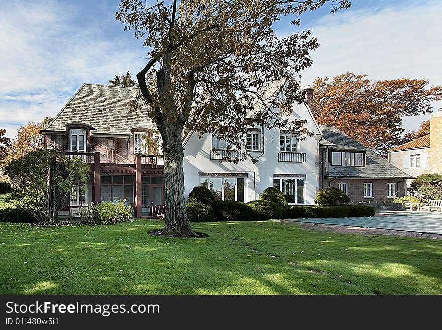 Rear view of luxury brick home during autumn. Rear view of luxury brick home during autumn