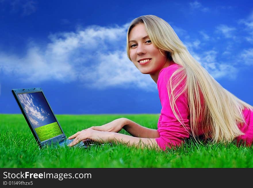 Beautiful Girl With Laptop On The Green Grass