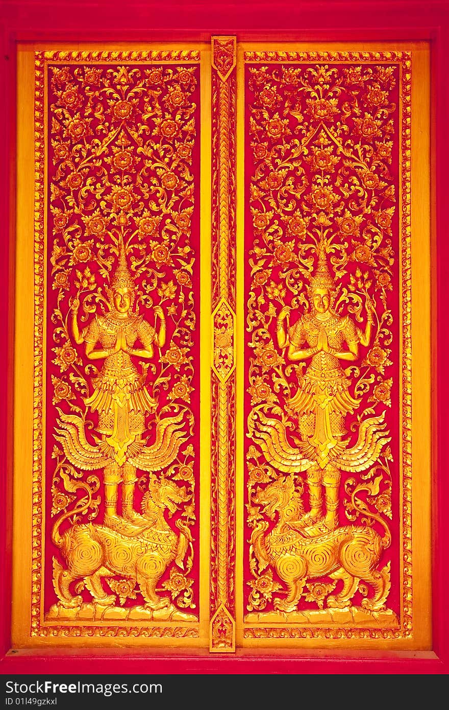 Traditional Thai art church door of Wat Klang Wiang, Chiang Rai province, Thailand