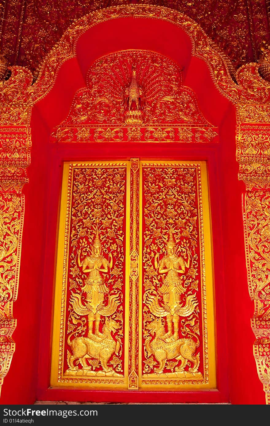 Traditional Thai art church door of Wat Klang Wiang, Chiang Rai province, Thailand