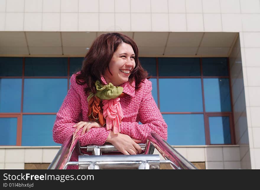 Happy smiling young women in pink coat