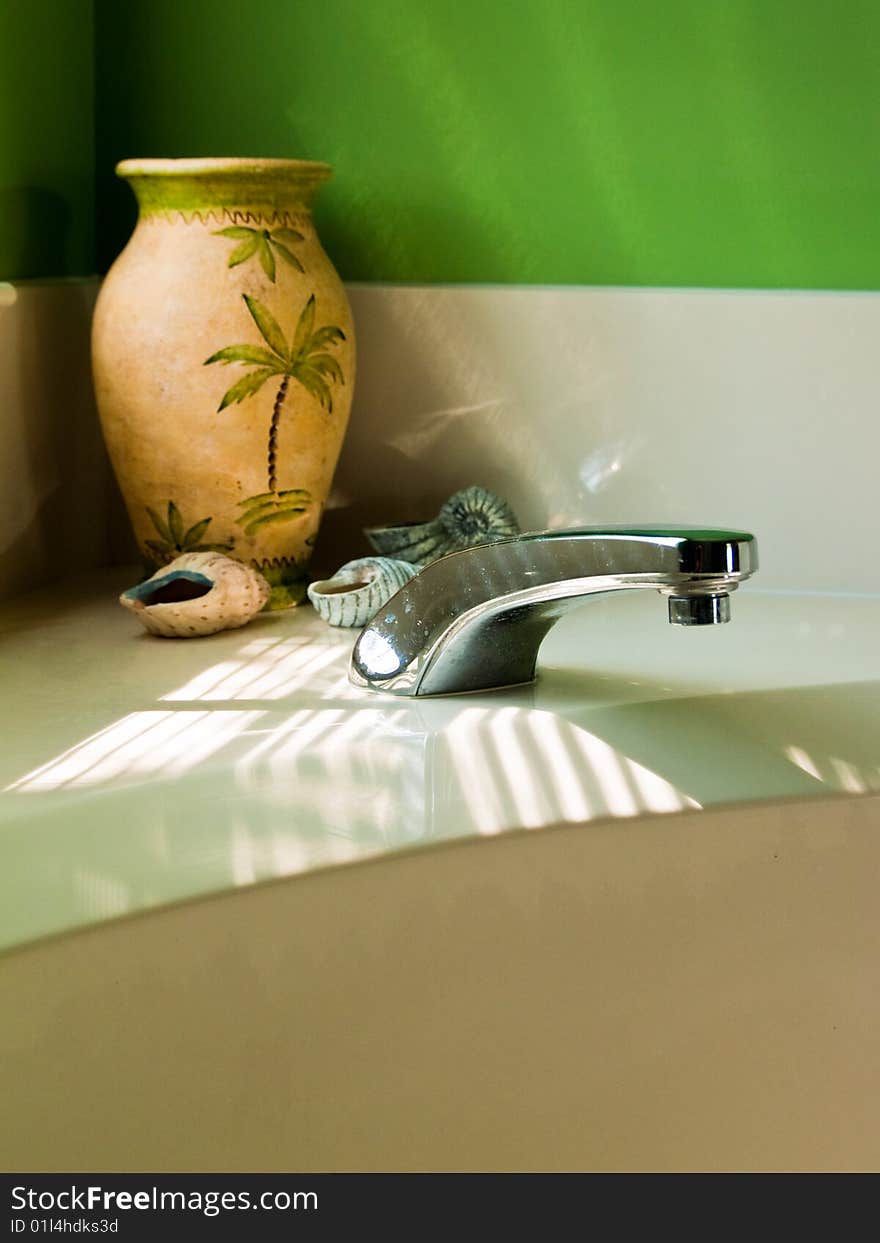 Crafted Seashells and Vase on a white ledge in the corner of a modern, luxurious Bathroom. Crafted Seashells and Vase on a white ledge in the corner of a modern, luxurious Bathroom.