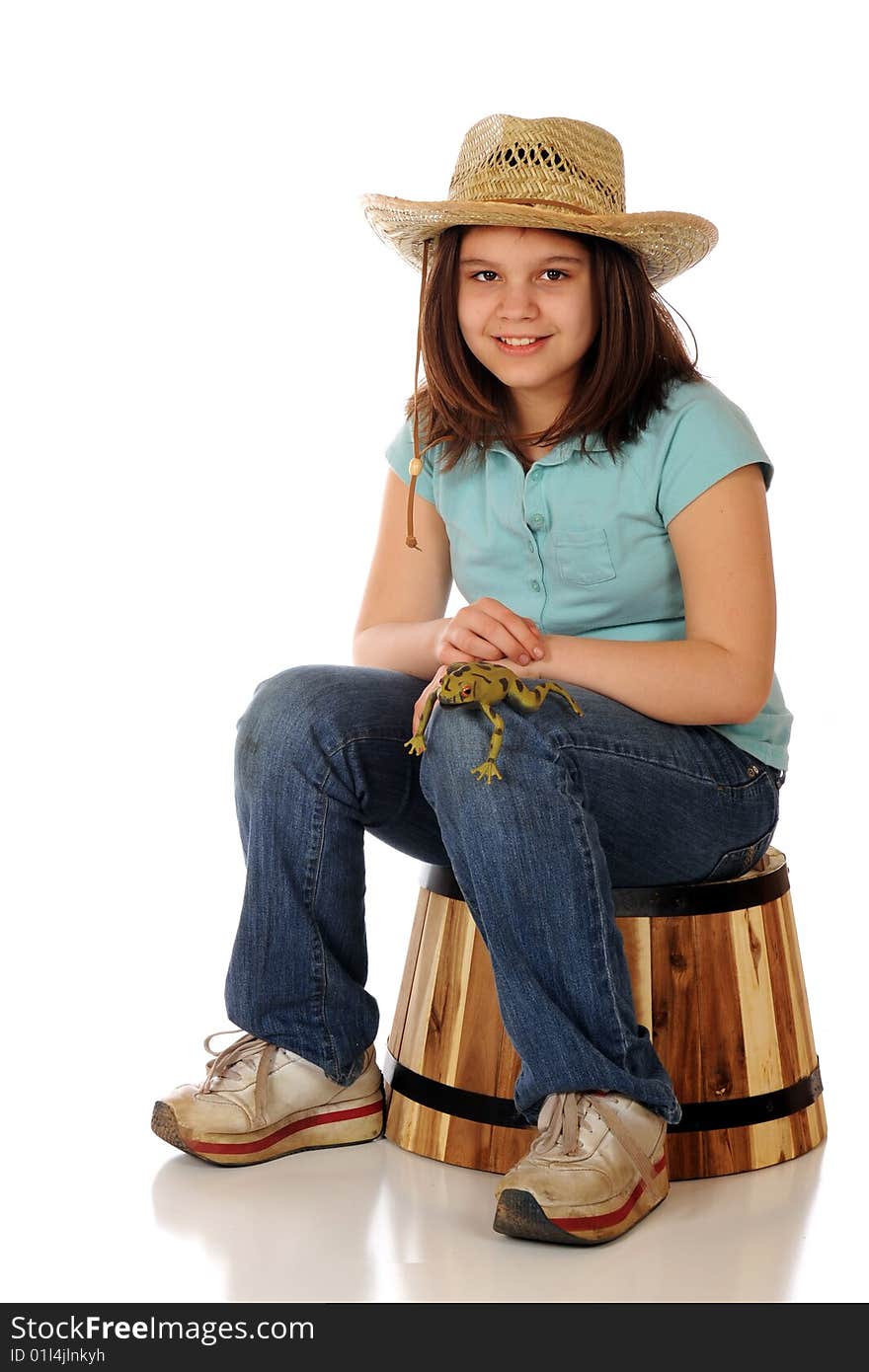 A preteen farmer-girl proudly displaying a large, spotted green frog on her knee.  Isolated on white. A preteen farmer-girl proudly displaying a large, spotted green frog on her knee.  Isolated on white.