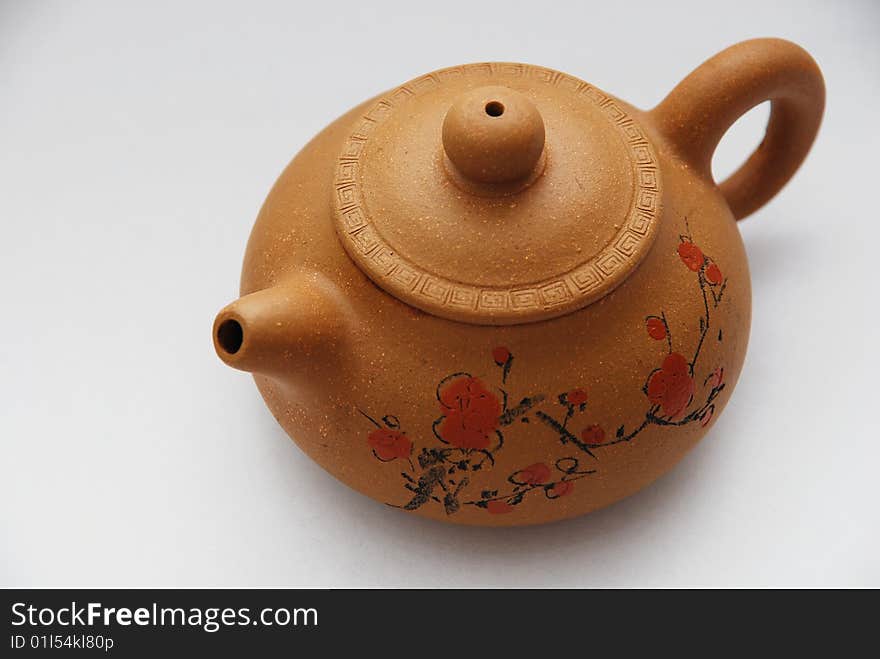 Chinese ceramic teapot with ornament on white background