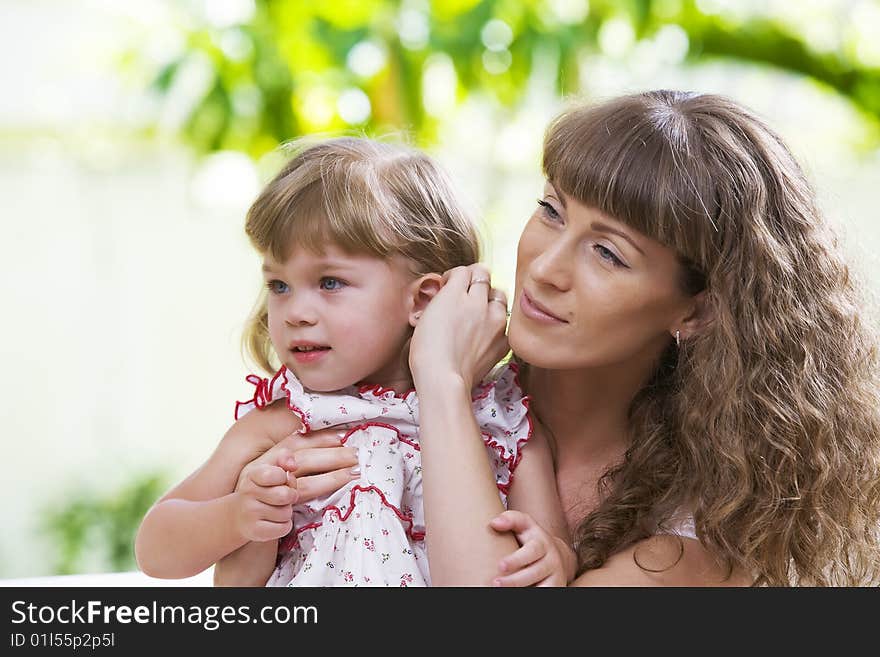 Portrait of happy mother with daughter  having good time in summer environment. Portrait of happy mother with daughter  having good time in summer environment