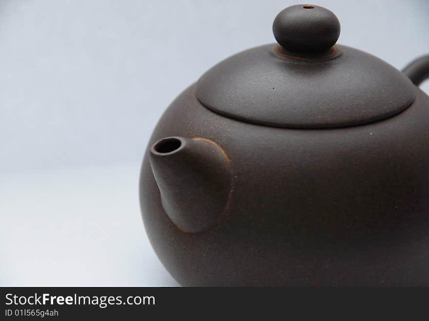 Chinese ceramic teapot with ornament on white background