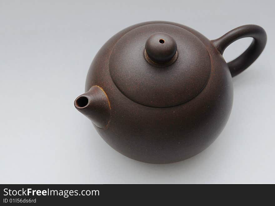 Chinese ceramic teapot with ornament on white background