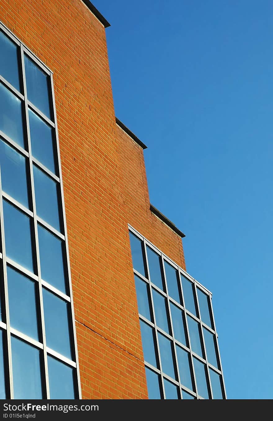 Brick and glass architecture against blue sky. Brick and glass architecture against blue sky