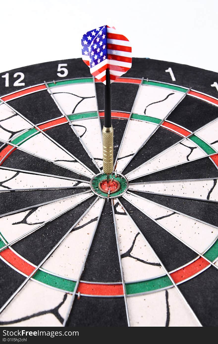 Darts target with a dart stuck in the center,numerous target
and practice.