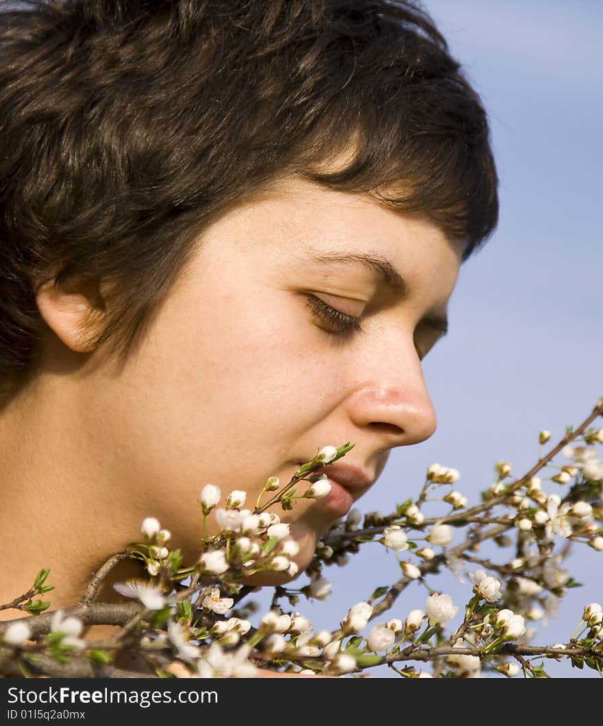 Beautiful woman amongst spring blossom