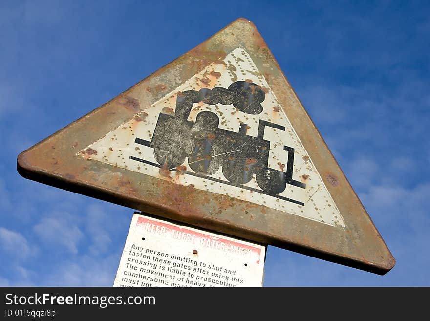 An old road sign with steam locomotive image. An old road sign with steam locomotive image