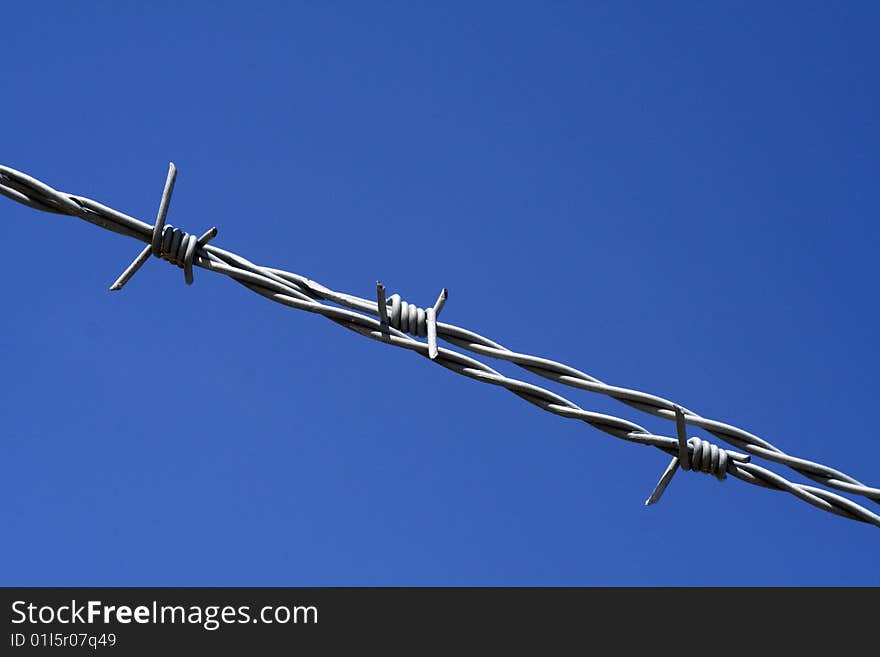 Barbed wire with a blue sky background