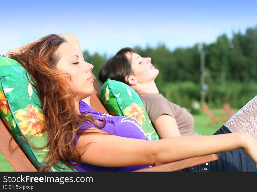 Two young girls relaxing outdoors