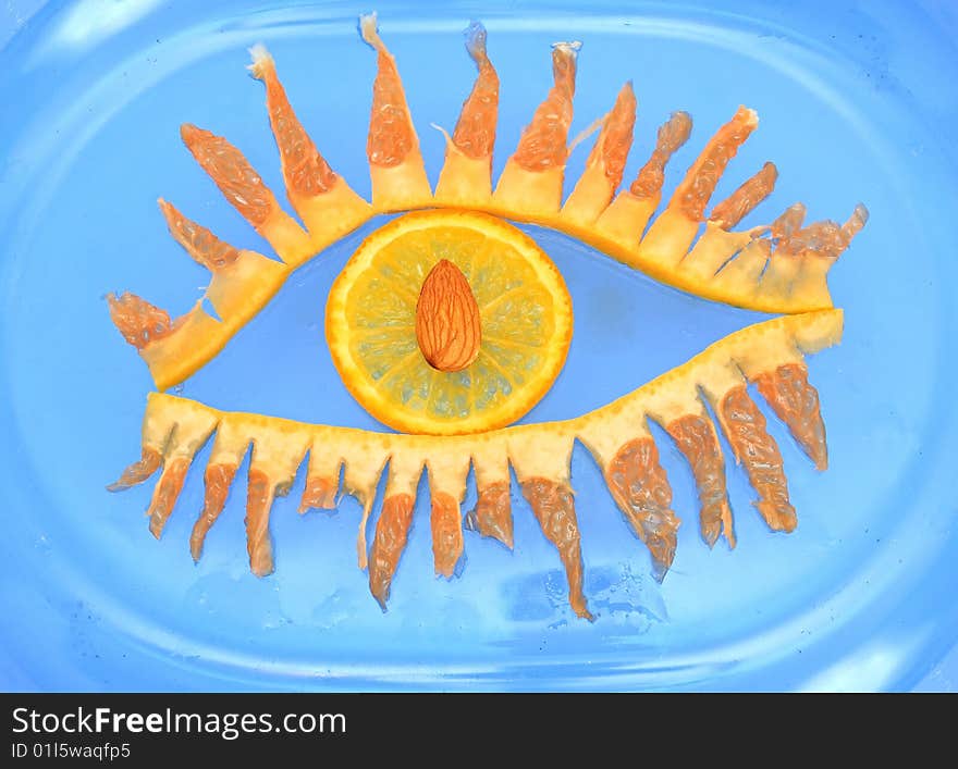 Eye from fruit on a blue background.