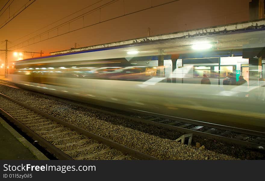 Train in motion near railway platform