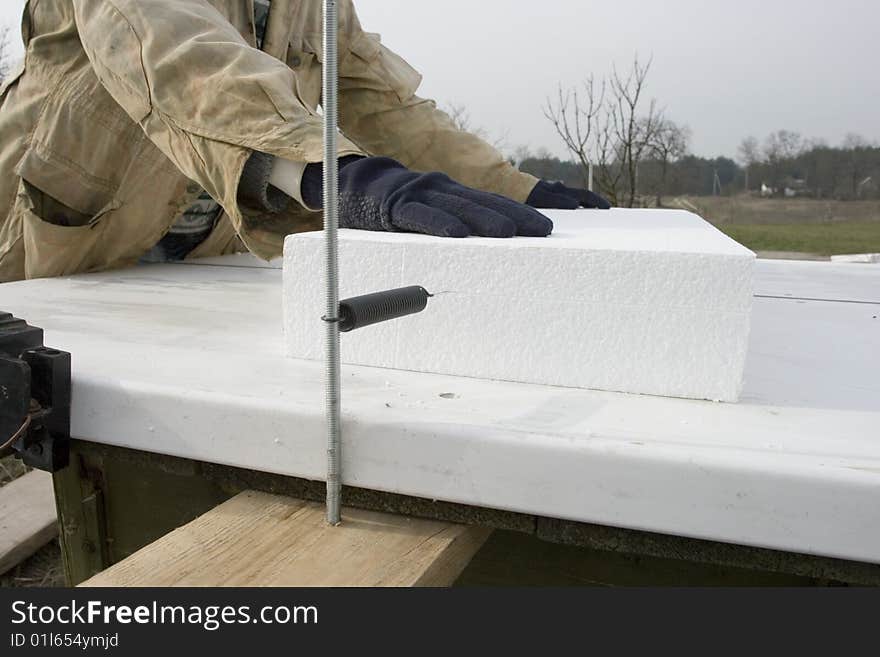 builder cuts polystyrene. cutting part - an incandescent string