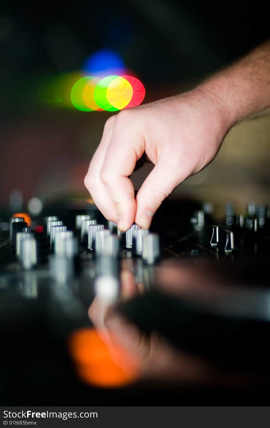 Close-up of deejays hand and turntable