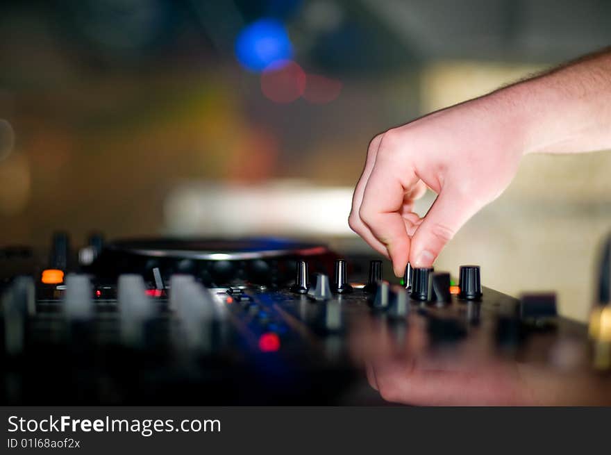 Close-up of deejays hand and turntable